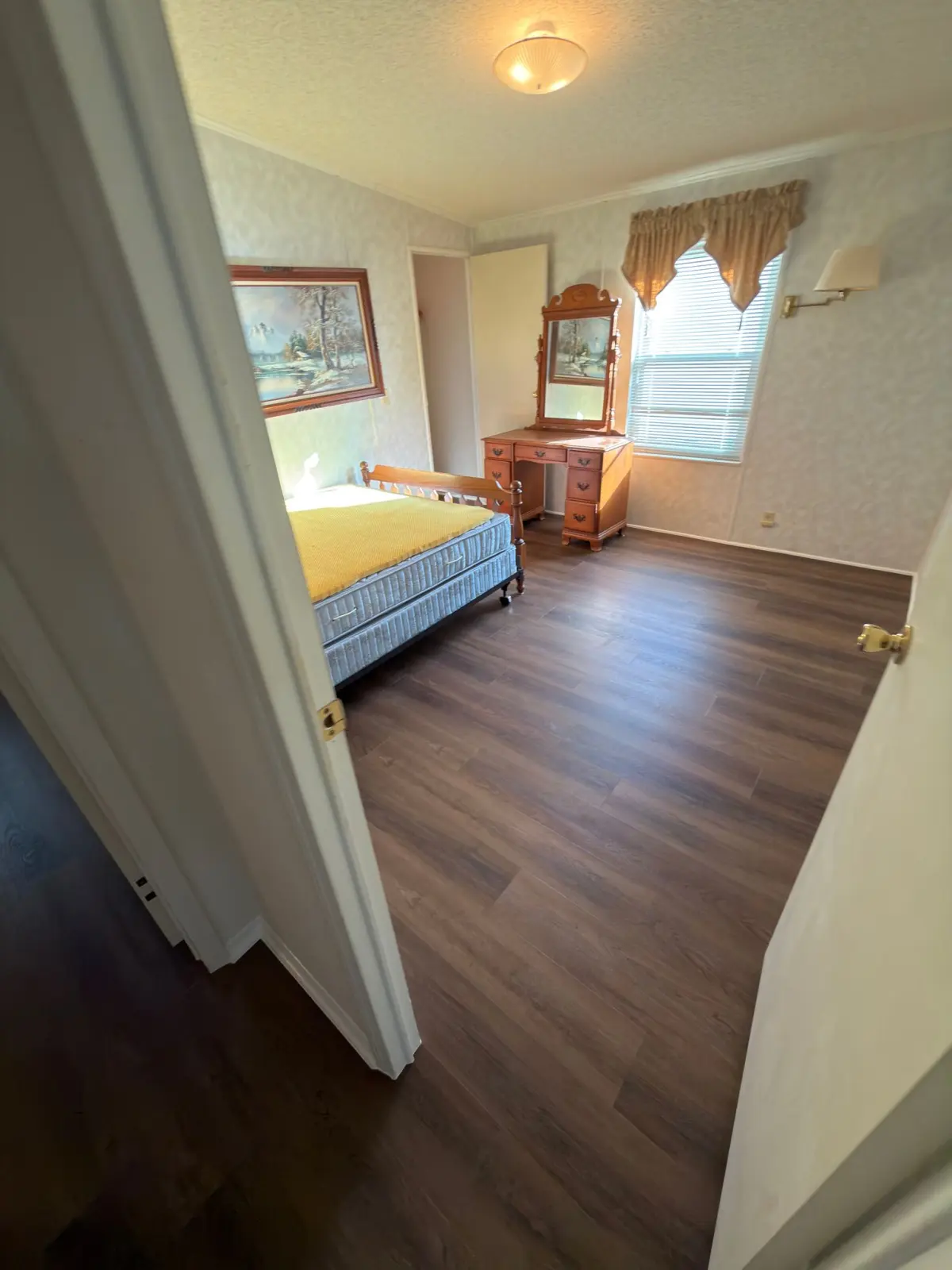 Bedroom with wide-plank luxury vinyl flooring in a Summerfield, FL home