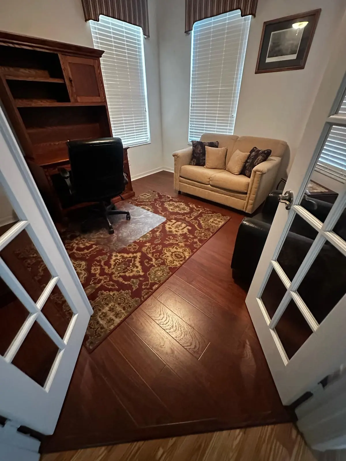 Home office with dark wood-look flooring in a Summerfield, FL home