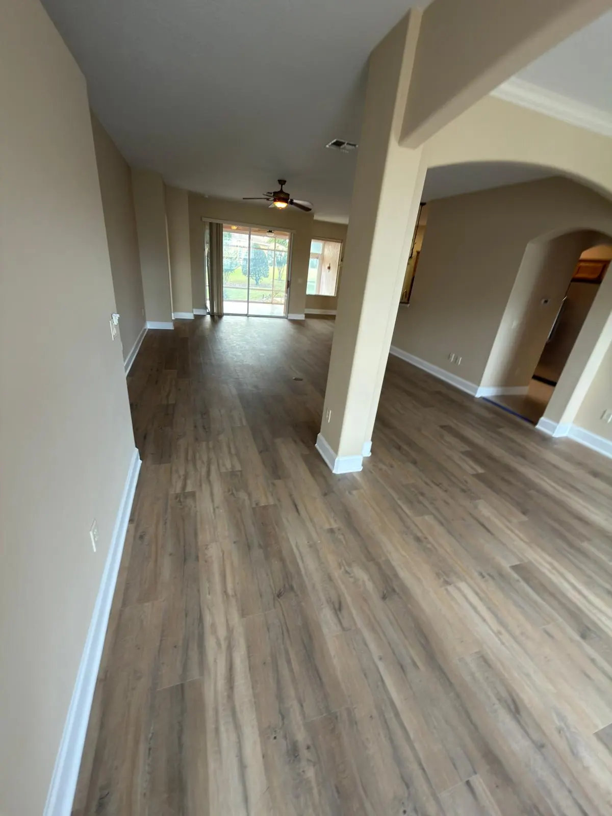 Open living area in gray wood-look luxury vinyl plank in a Summerfield, FL home