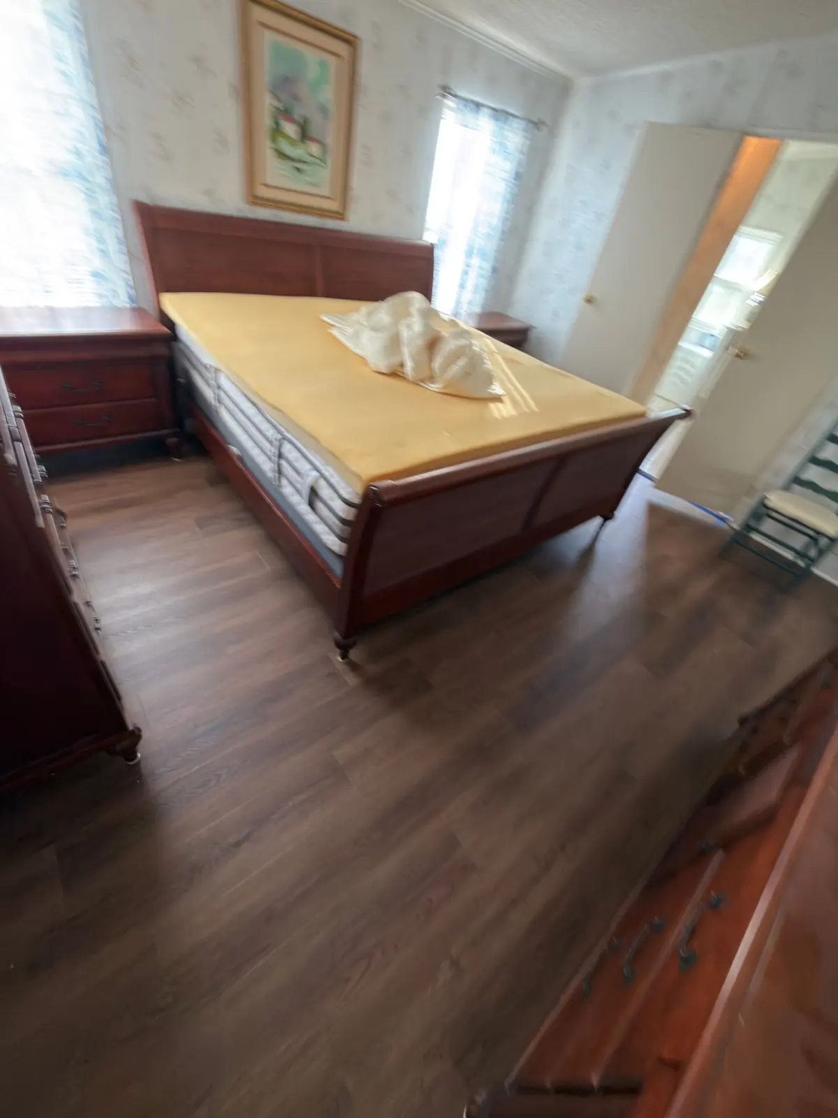 Main bedroom with wood-look luxury vinyl plank in a Summerfield, FL home