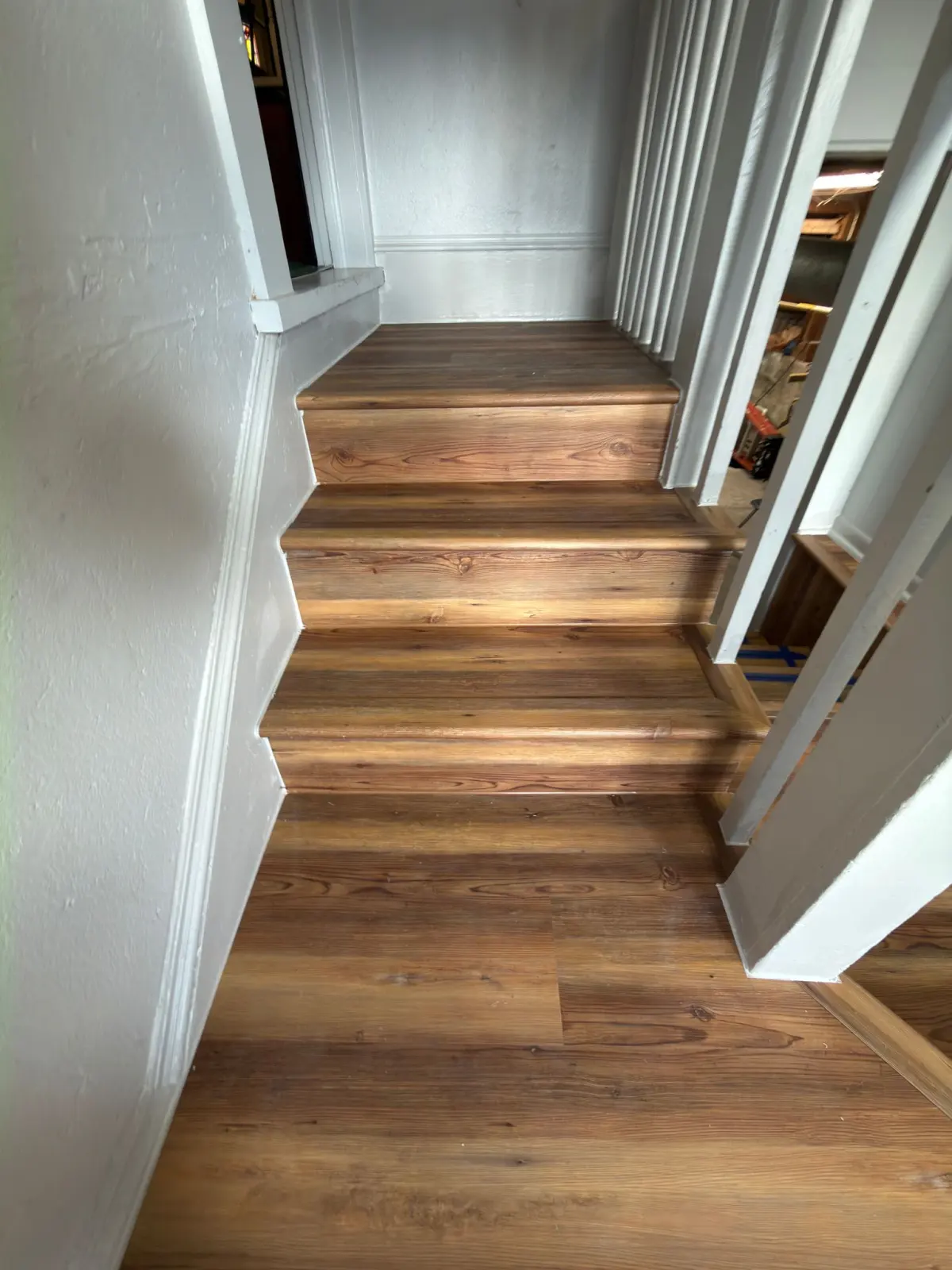 Stair landing and hallway in wide-plank flooring in a Summerfield, FL home