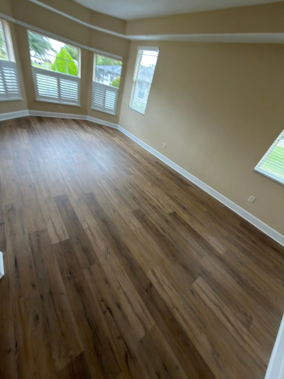 Open living area in light gray luxury vinyl plank in a Summerfield, FL home