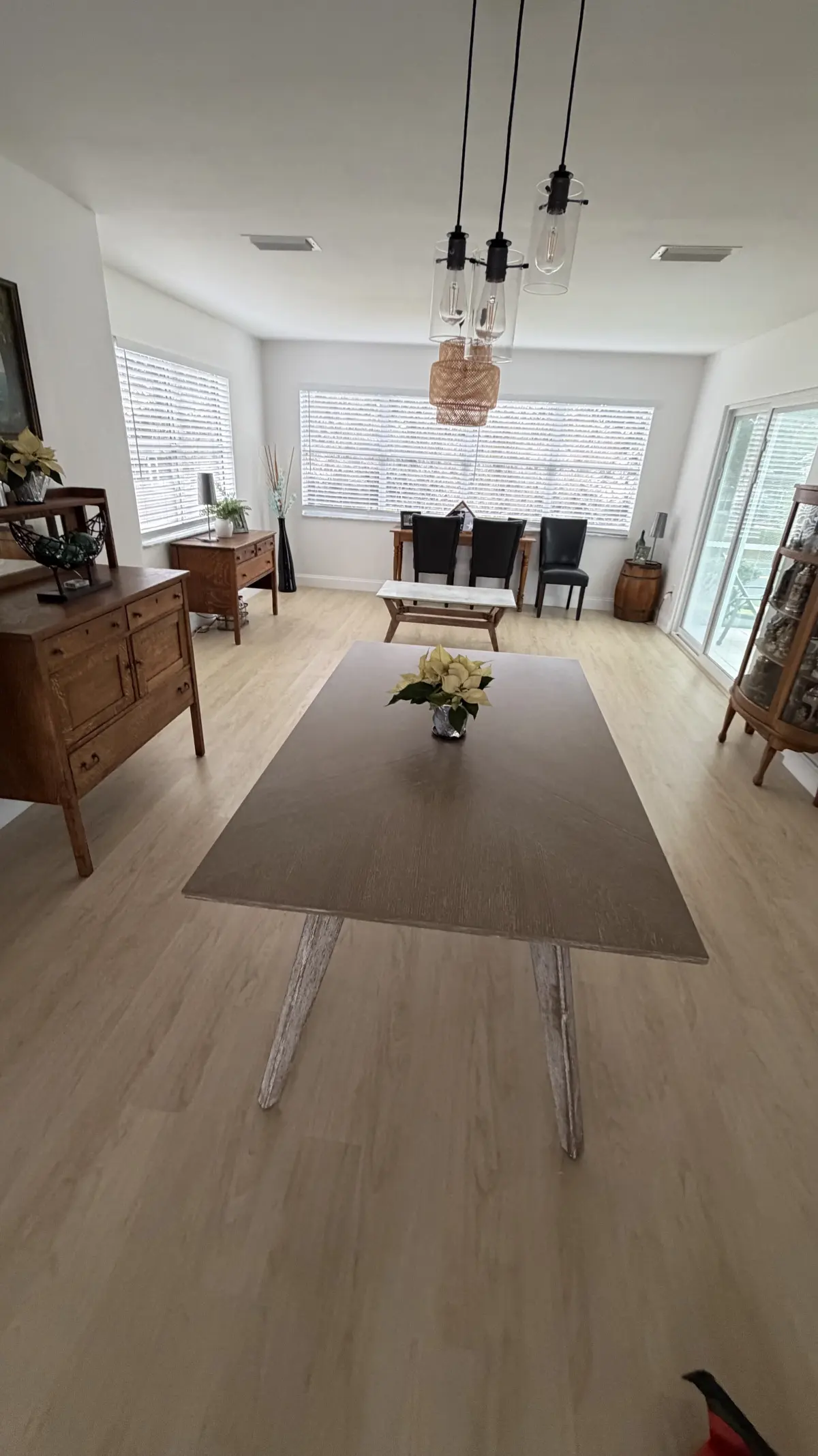 Great room with wide-plank flooring and a dining table in a Summerfield, FL home