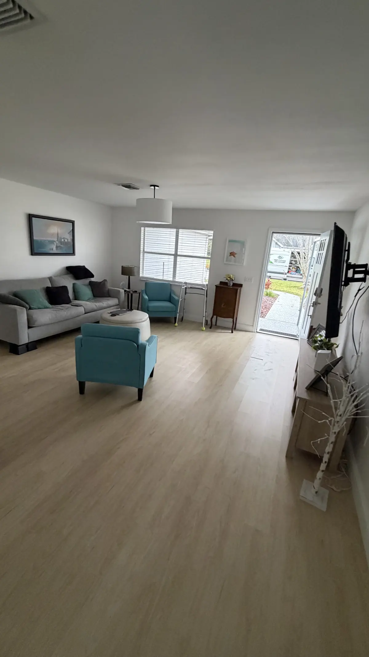 Furnished living room in light wood-look plank in a Summerfield, FL home