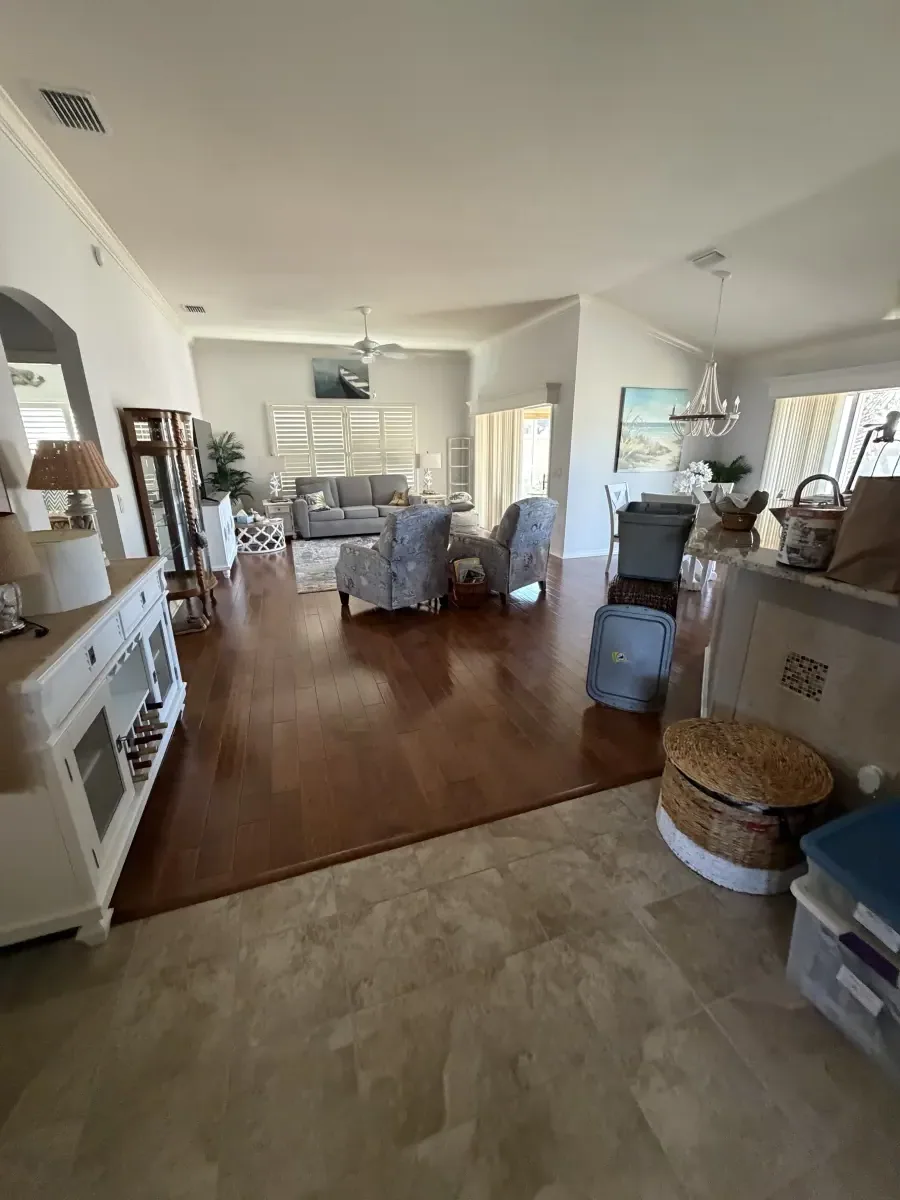 Living and dining area in dark wood-look flooring in a Summerfield, FL home
