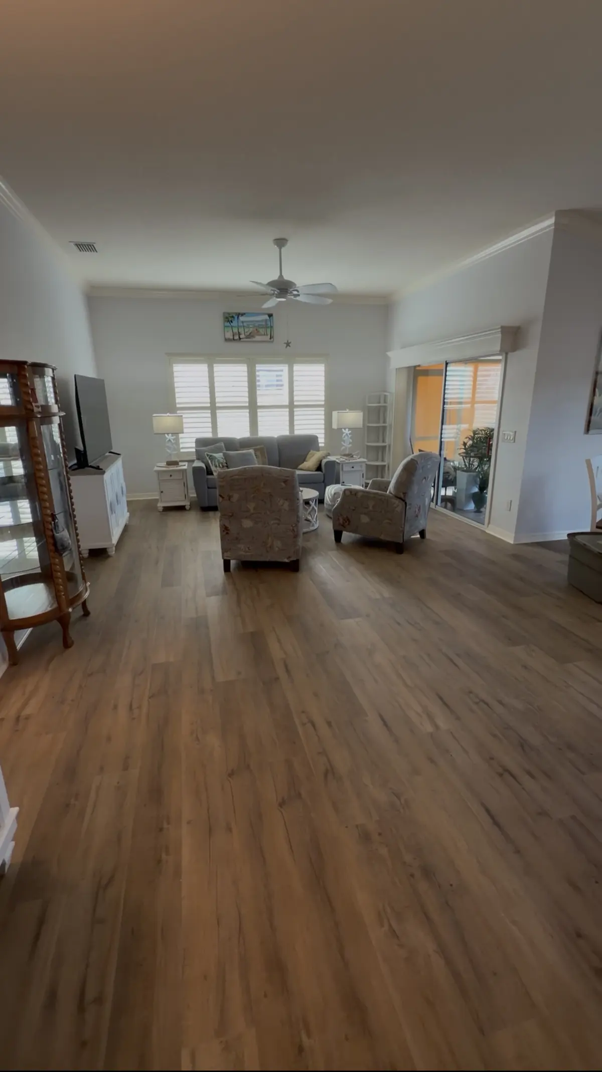 Open living room in wood-look luxury vinyl plank in a Summerfield, FL home