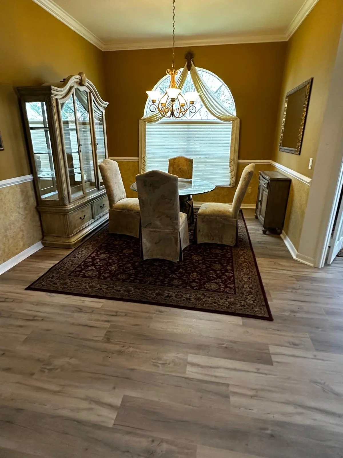 Formal dining room with wood-look plank flooring in a Summerfield, FL home
