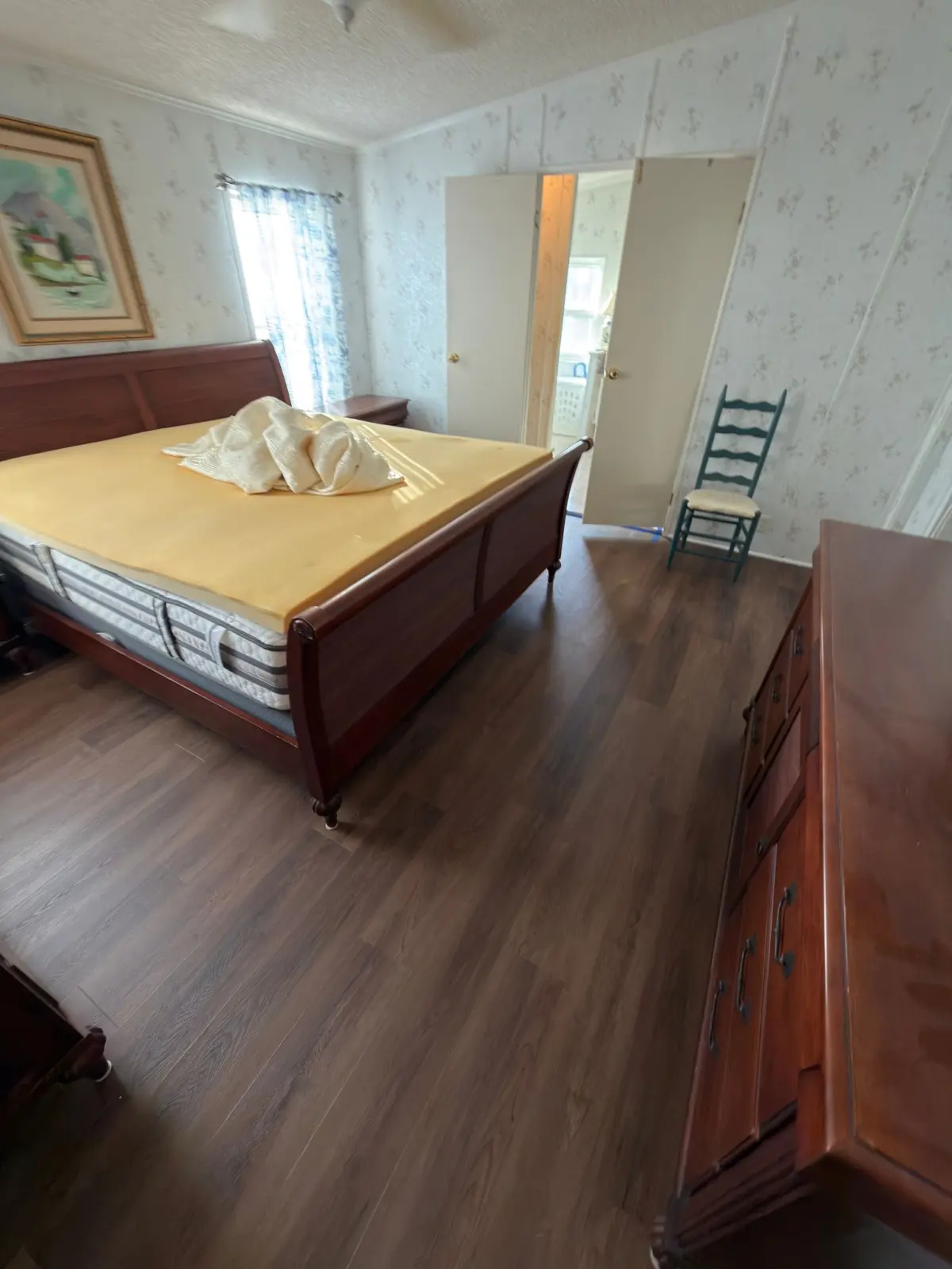 Bedroom finished in warm wood-look plank in a Summerfield, FL home