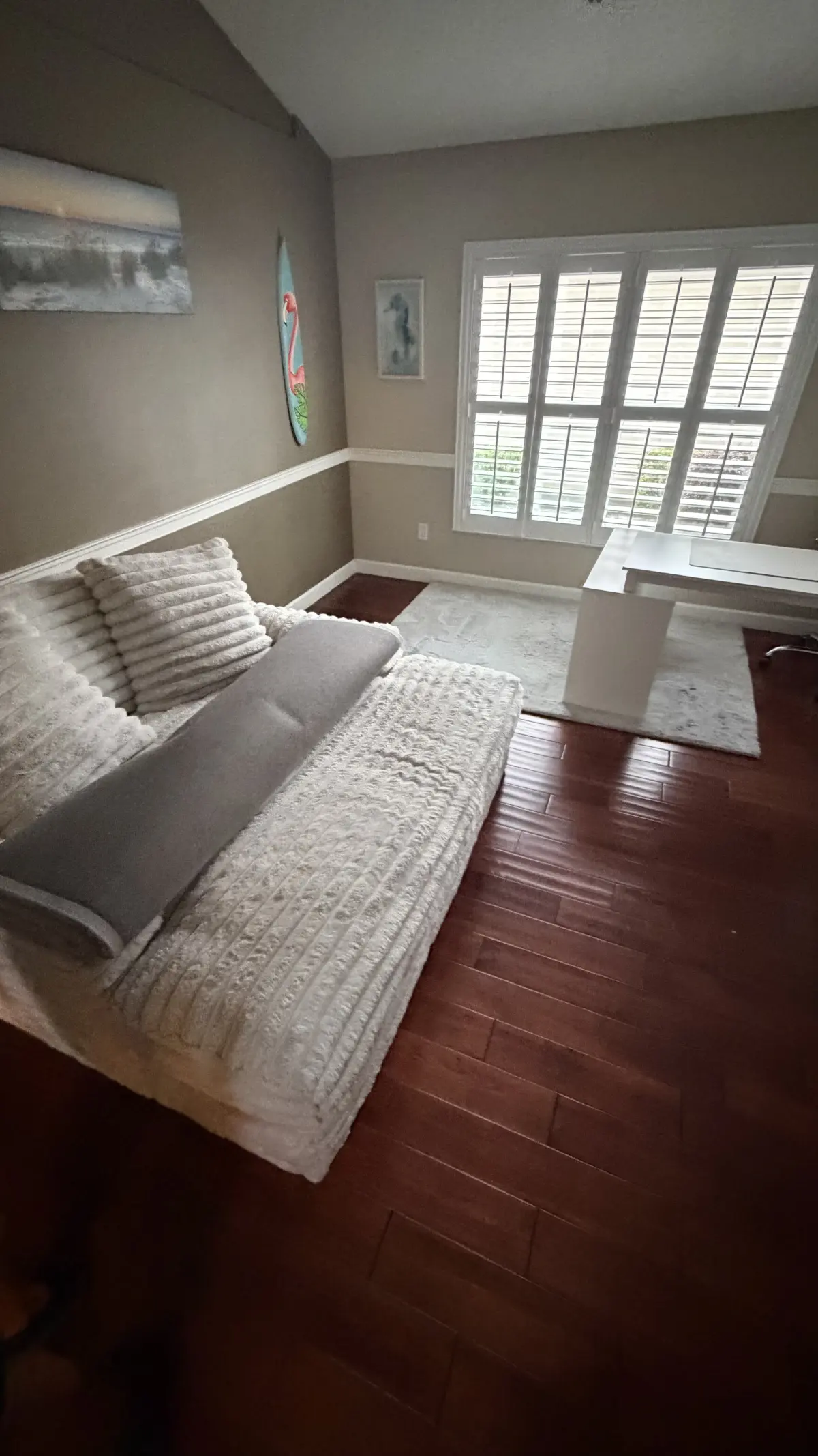 Living room in dark red-toned wood flooring in a Summerfield, FL home