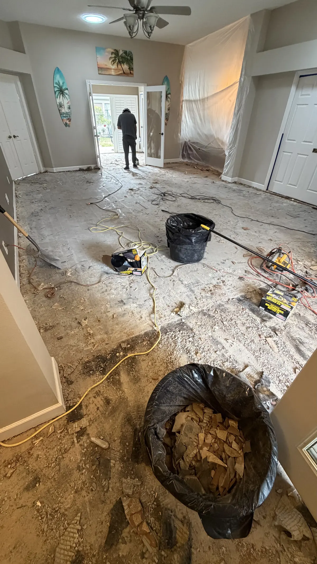 Old flooring being torn out and hauled away in a Summerfield, FL home