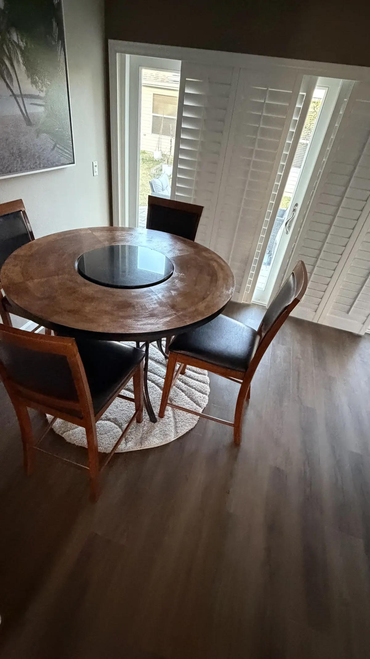Dining area in medium wood-look plank flooring in a Summerfield, FL home