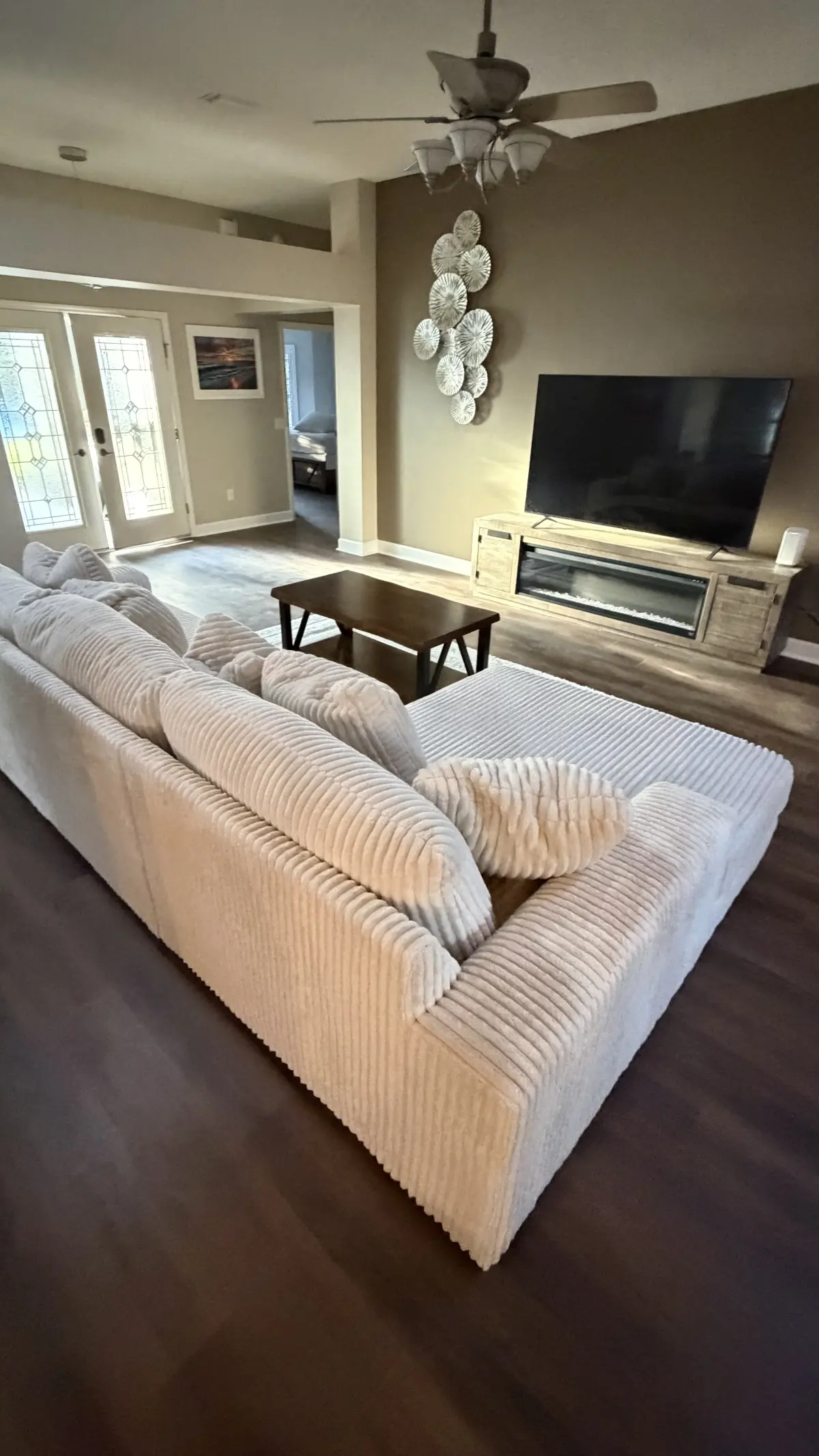 Living room in dark wood-look luxury vinyl plank in a Summerfield, FL home