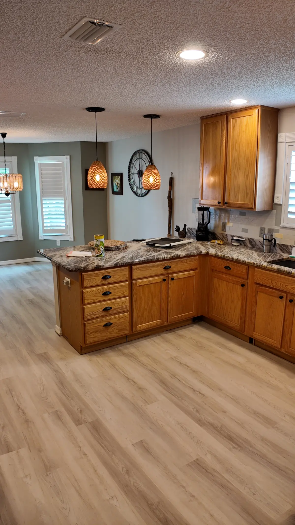 Kitchen in light wood-look luxury vinyl plank in a Summerfield, FL home