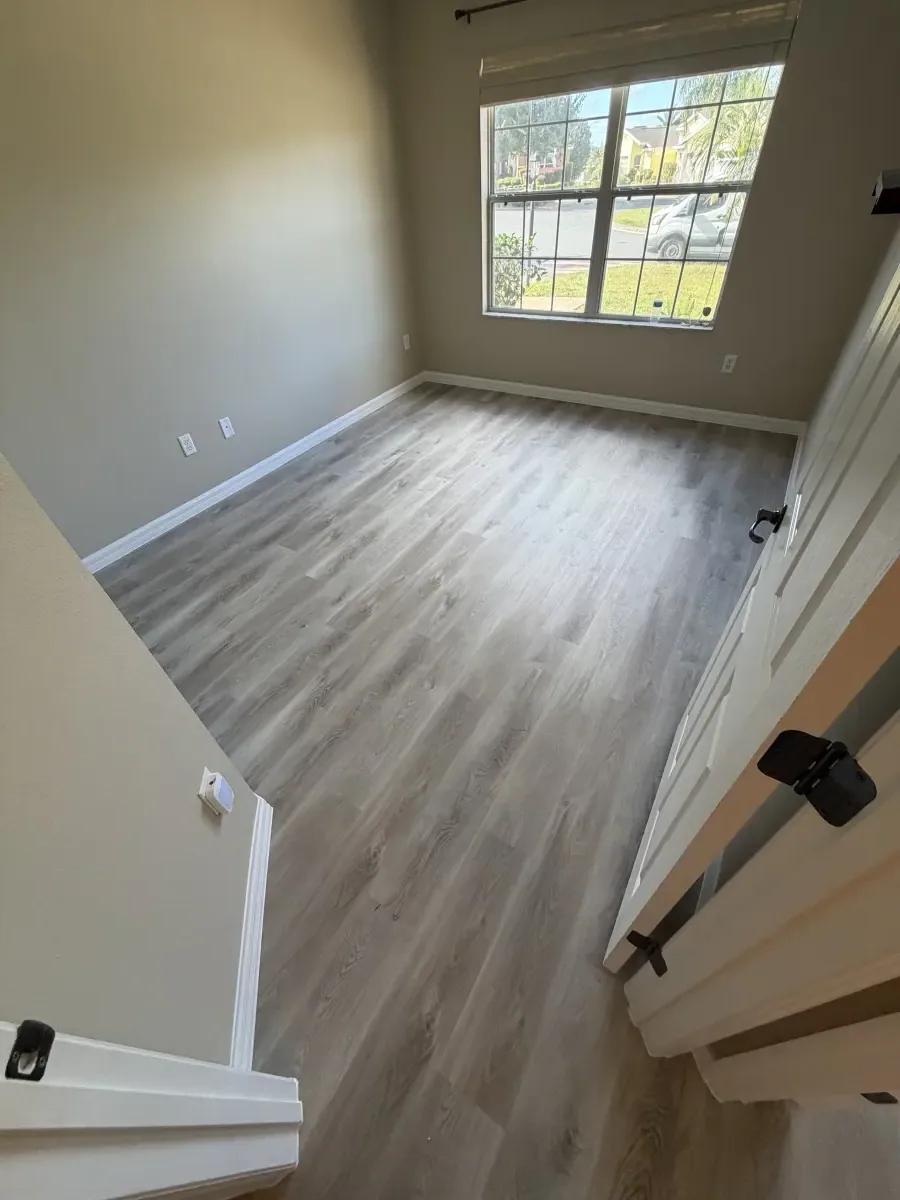 Stairway landing in light gray wood-look plank in a Summerfield, FL home