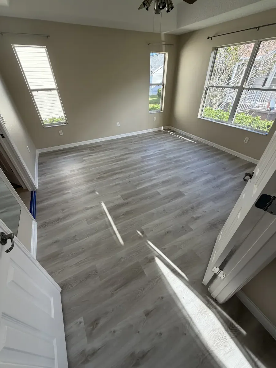 Open living area in light gray wide-plank flooring in a Summerfield, FL home