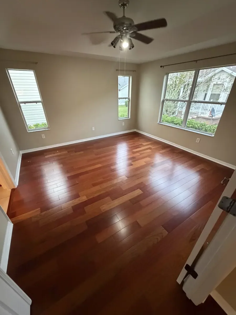 Living room in cherry-toned wood flooring in a Summerfield, FL home