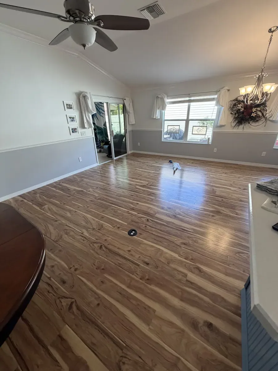 Open living area in light wood-look plank in a Summerfield, FL home