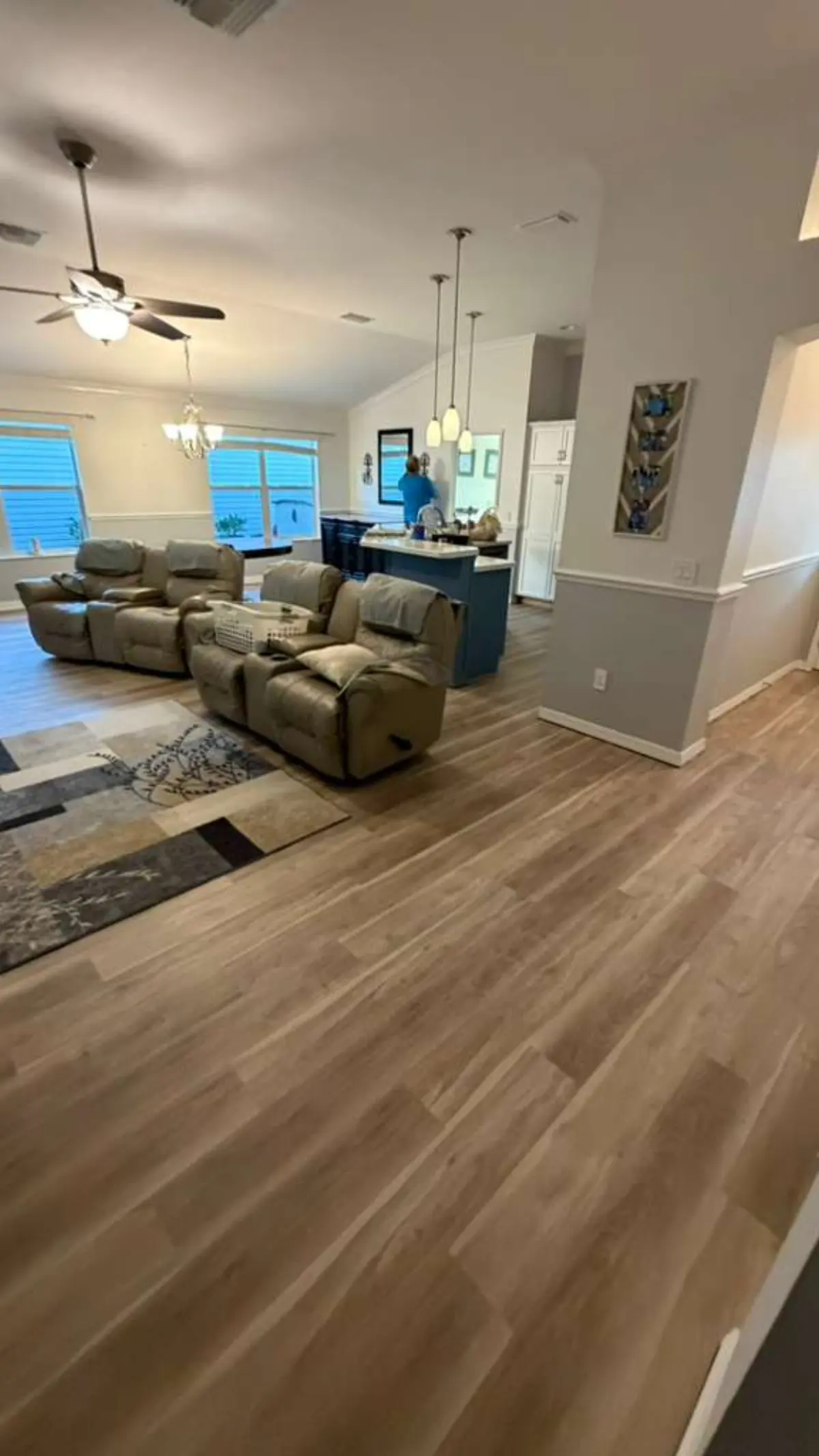 Open living room and kitchen in a Summerfield, FL home finished with wide-plank luxury vinyl flooring by MCP Flooring