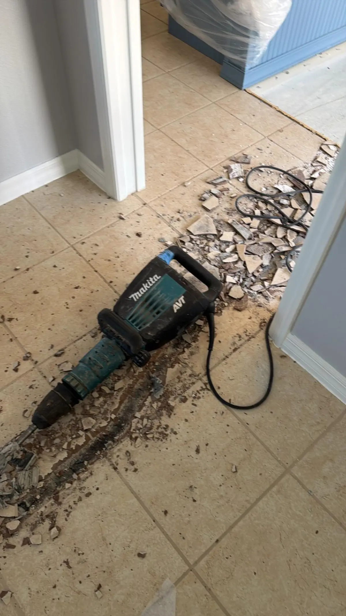 Old ceramic tile being broken out of a floor in a Summerfield, FL home