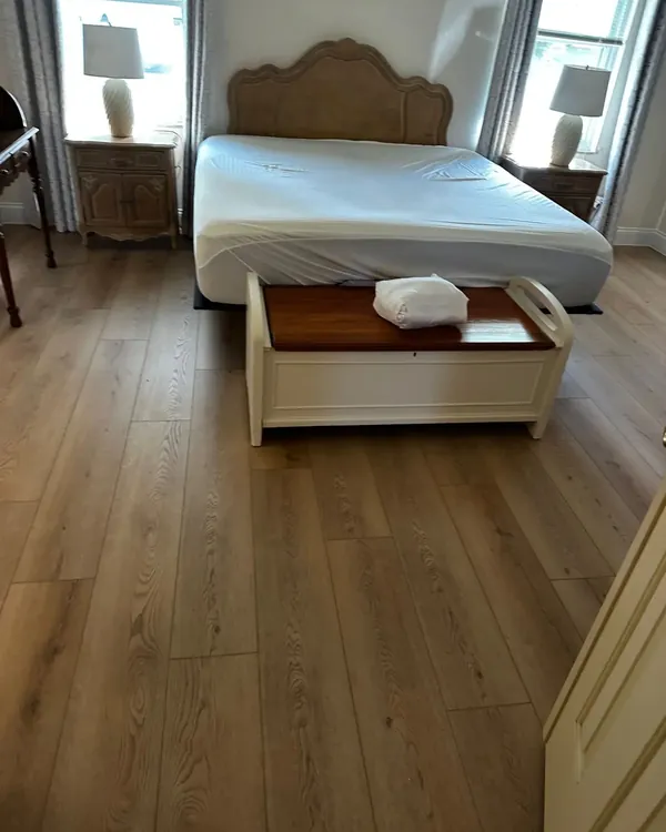 Bedroom with light oak-look luxury vinyl plank
