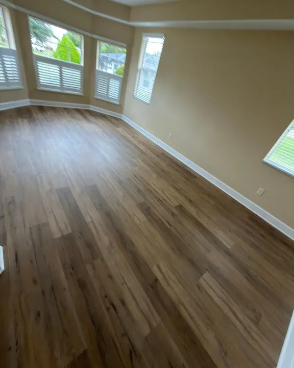 Open living area in light gray luxury vinyl plank