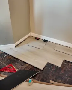Luxury vinyl planks being laid over a prepared slab